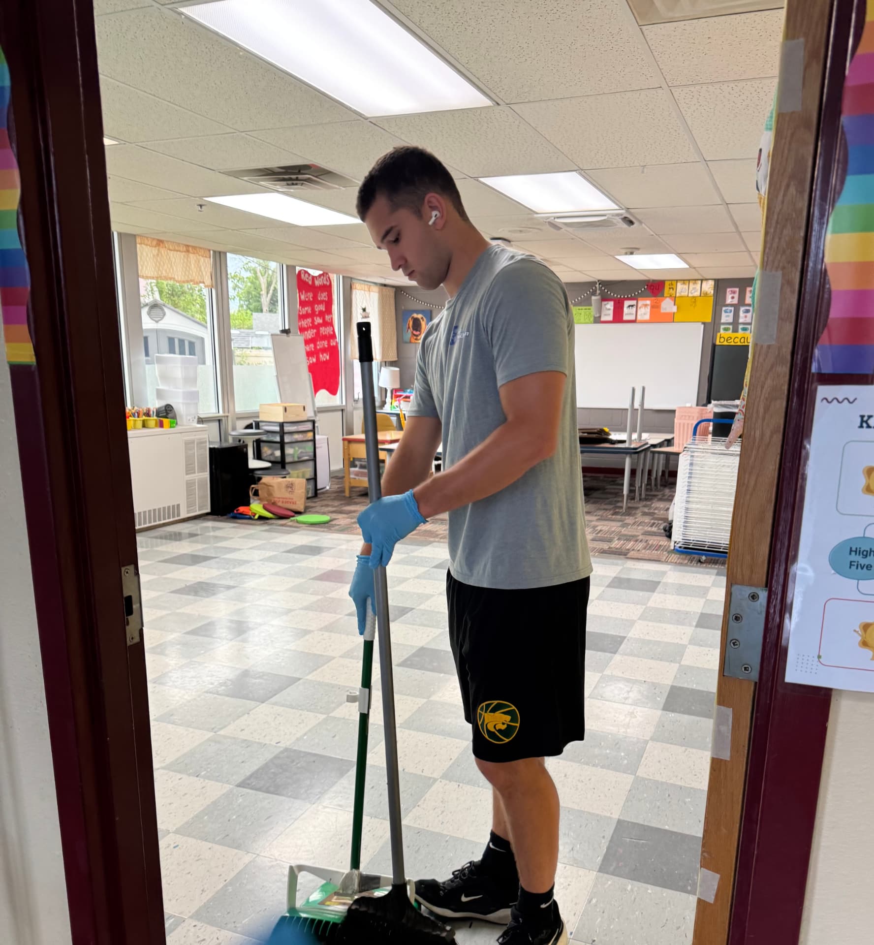 Team member mopping a classroom floor