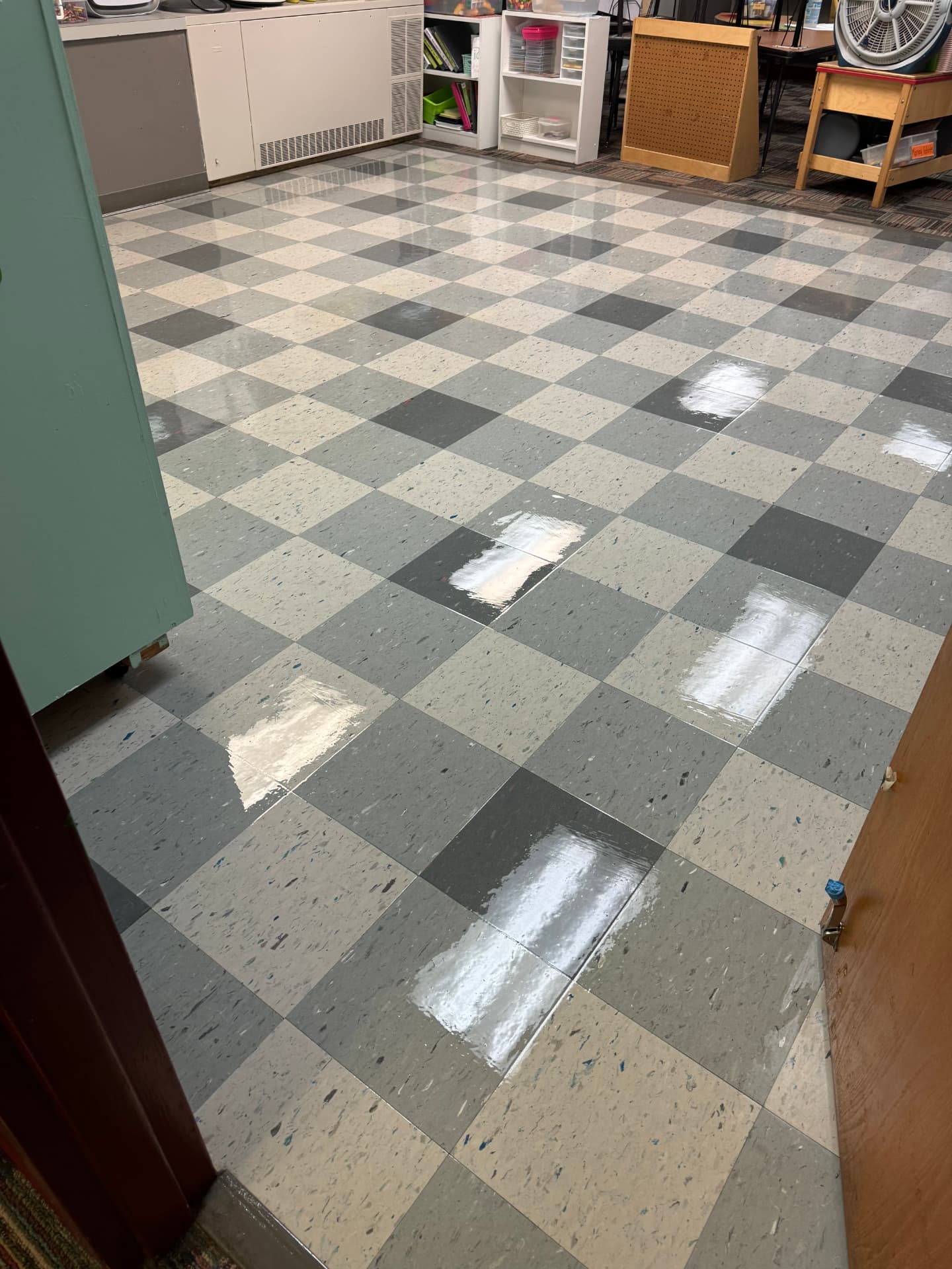 Freshly waxed checkered tile floor in a classroom